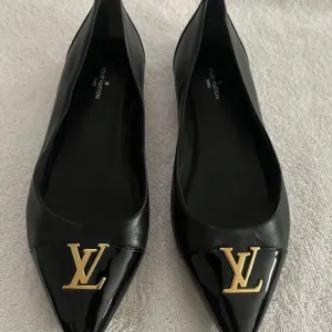 Louis Vuitton Black Flats with Gold Logo
