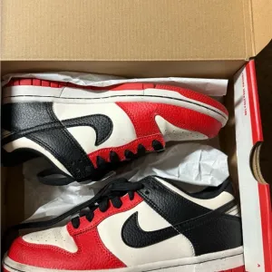 Nike Dunk Low GS in Black and Chile Red