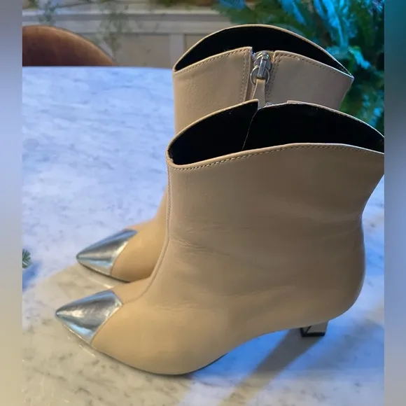 Silver tipped cream booties by Cecelia