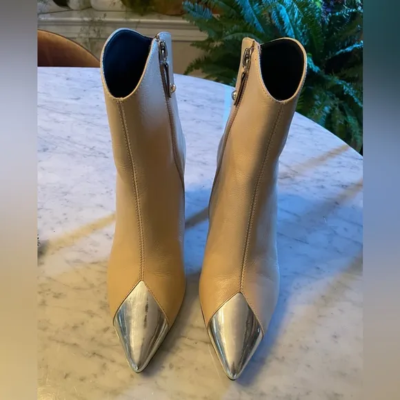 Silver tipped cream booties by Cecelia