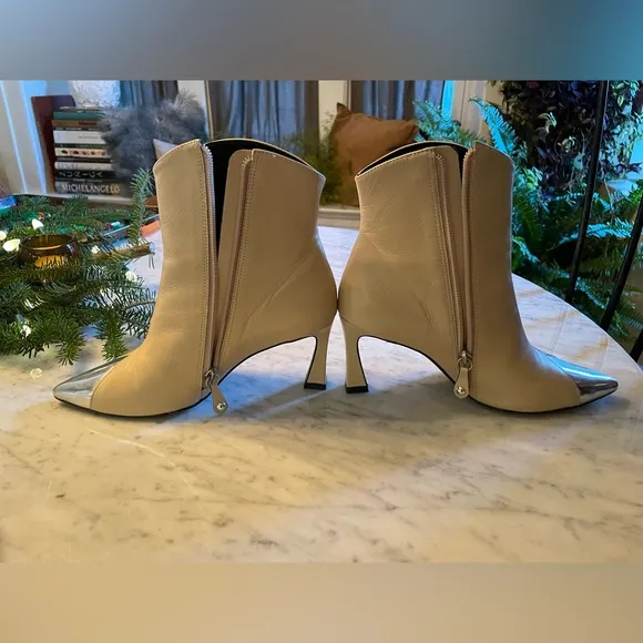 Silver tipped cream booties by Cecelia