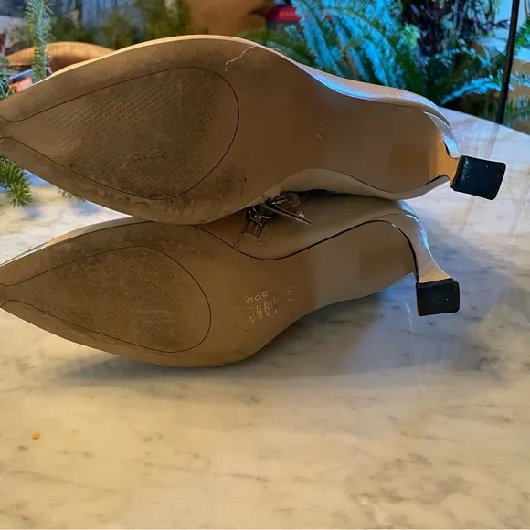 Silver tipped cream booties by Cecelia