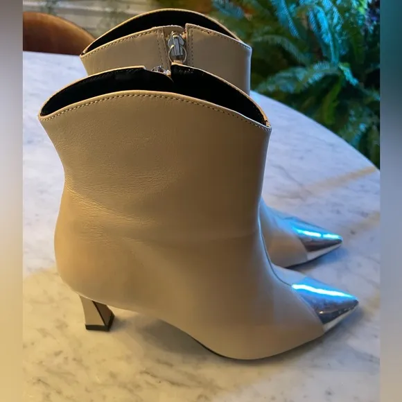 Silver tipped cream booties by Cecelia