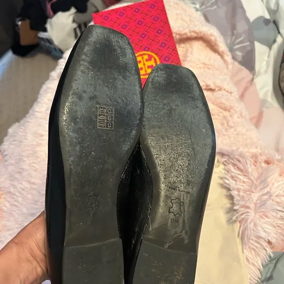 Tory Burch Black Flats with Embossed Logo and Glossy Finish